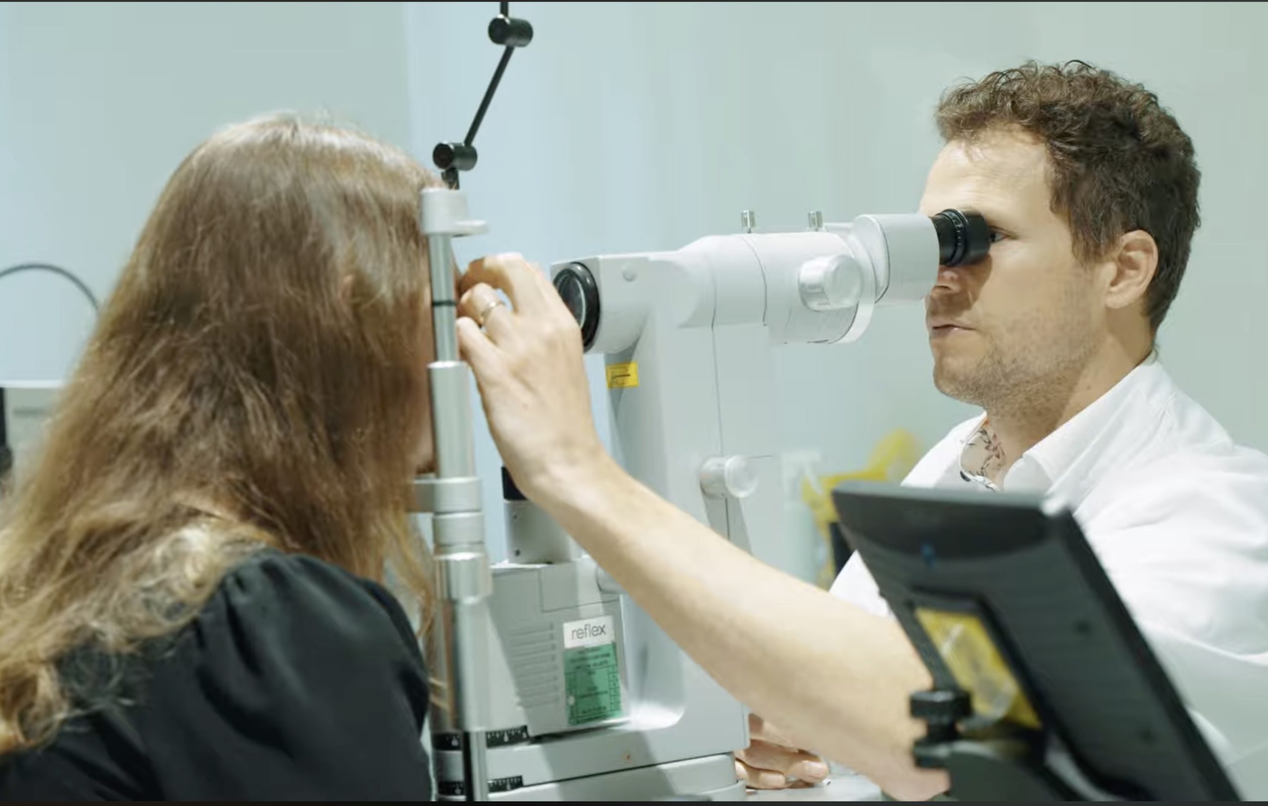 Le Dr-dugas ophtalmologue consultant une patiente en ragrdant le fond de l'oeil